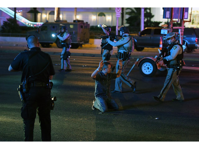 police officers stop a man who drove down tropicana ave near las vegas boulevard and tropicana ave which had been closed after a mass shooting at a country music festival that left at least 2 people dead nearby on october 2 2017 in las vegas nevada photo afp