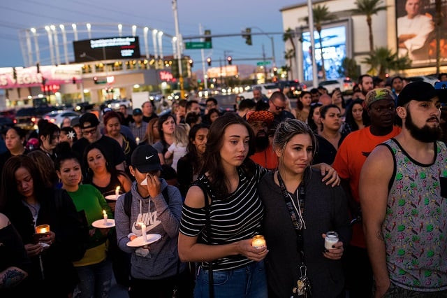 mourners attend a candlelight vigil at the corner of sahara avenue and las vegas boulevard for the victims of sunday night 039 s mass shooting october 2 2017 in las vegas nevada late sunday night a lone gunman killed more than 50 people and injured more than 500 people after he opened fire on a large crowd at the route 91 harvest festival a three day country music festival the massacre is one of the deadliest mass shooting events in us history photo afp