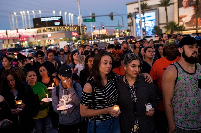 mourners attend a candlelight vigil at the corner of sahara avenue and las vegas boulevard for the victims of sunday night 039 s mass shooting october 2 2017 in las vegas nevada late sunday night a lone gunman killed more than 50 people and injured more than 500 people after he opened fire on a large crowd at the route 91 harvest festival a three day country music festival the massacre is one of the deadliest mass shooting events in us history photo afp
