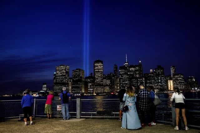 people watch the tribute in light installation illuminated over lower manhattan as seen from brooklyn marking the 16th anniversary of the 9 11 attacks in new york city photo reuters brendan mcdermid