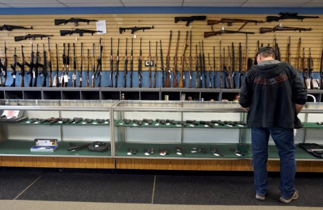 a customer looks over weapons for sale at the pony express firearms shop in parker colorado us photo reuters a customer looks over weapons for sale at the pony express firearms shop in parker colorado us photo reuters