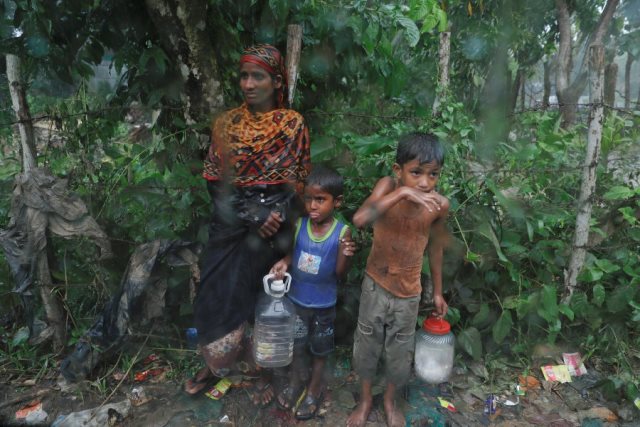 rohingya refugees stand by the road in the rain outside their camp near cox 039 s bazar bangladesh october 3 2017 photo reuters