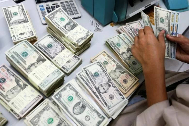 a bank employee counts u s dollar photo reuters a bank employee counts u s dollar photo reuters