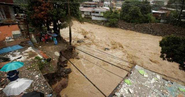 people look at a street collapsed by the tiribi river flooded by heavy rains from tropical storm nate in san jose costa rica october 5 2017 photo reuters people look at a street collapsed by the tiribi river flooded by heavy rains from tropical storm nate in san jose costa rica october 5 2017 photo reuters