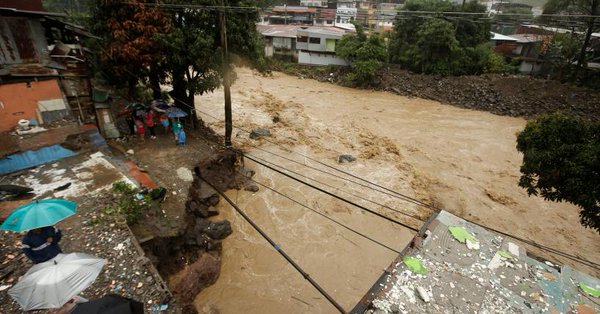 people look at a street collapsed by the tiribi river flooded by heavy rains from tropical storm nate in san jose costa rica october 5 2017 photo reuters