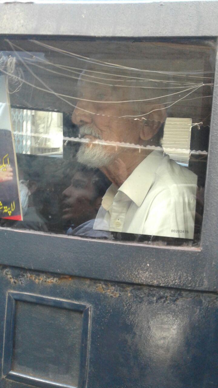 father of missing person samar abbas sitting inside the police van after surrendering his arrest