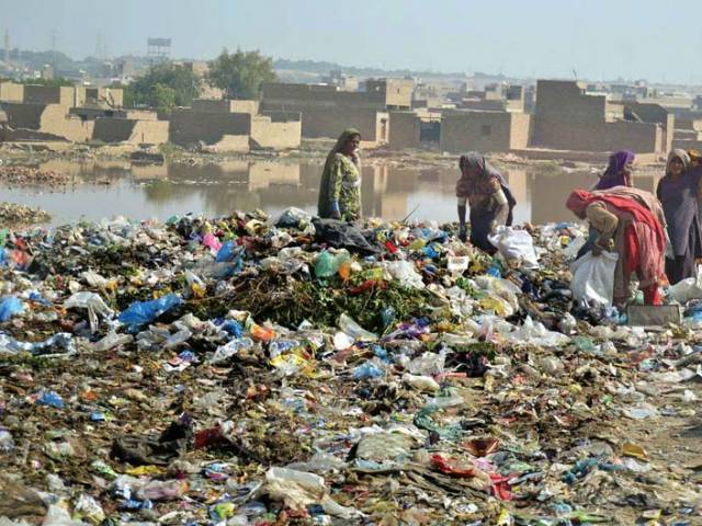 women look for valuables in a garbage dump at phuleli canal photo file