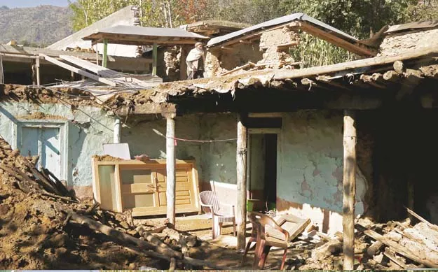 people walk past the rubble of a house damaged by earthquake in the village of aryankoat near dir bala photo reuters people walk past the rubble of a house damaged by earthquake in the village of aryankoat near dir bala photo reuters