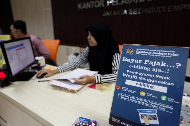 an employee at a government tax office sits behind a desk in jakarta indonesia february 23 2017 photo reuters