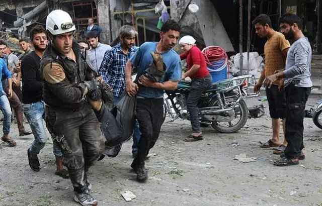 rescuers including members of the syrian civil defence also known as white helmets carry a victim of a reported air strike on a vegetable market in maaret al numan in idlib province on october 8 2017 photo afp rescuers including members of the syrian civil defence also known as white helmets carry a victim of a reported air strike on a vegetable market in maaret al numan in idlib province on october 8 2017 photo afp