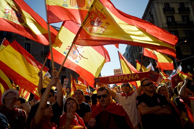 people wave spanish flags during a demonstration called by quot societat civil catalana quot catalan civil society to support the unity of spain on october 8 2017 in barcelona spain braced for more protests despite tentative signs that the sides may be seeking to defuse the crisis after madrid offered a first apology to catalans injured by police during their outlawed independence vote photo afp