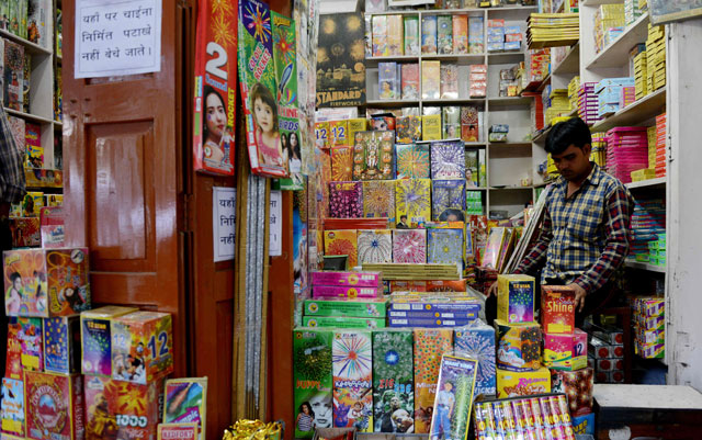 an indian shopkeeper waits for customers at his firecracker shop in new delhi on october 9 2017 photo afp