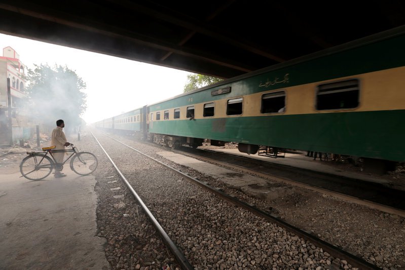 a man waits to cross a portion of track once shared with the disused karachi circular railway line in karachi pakistan may 24 2017 photo reuters