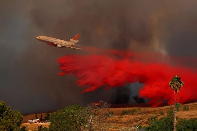a dc 10 aircraft drops fire retardant on a wind driven wildfire in orange california us photo reuters a dc 10 aircraft drops fire retardant on a wind driven wildfire in orange california us photo reuters