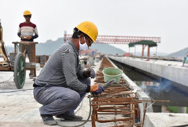 a worker welds reinforcement bars at a site of a highway bridge under construction in hefei anhui province china september 21 2017 photo reuters a worker welds reinforcement bars at a site of a highway bridge under construction in hefei anhui province china september 21 2017 photo reuters