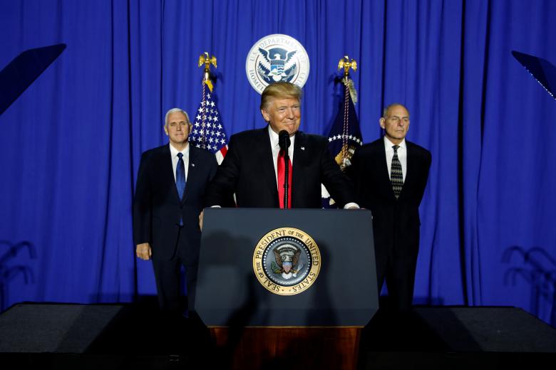 president trump flanked by vice president mike pence and homeland security secretary john kelly at the homeland security headquarters photo reuters