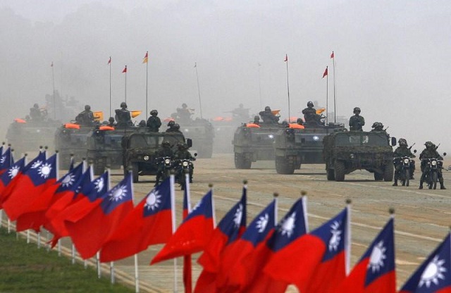 soldiers drive their military vehicles past taiwan flags during an army exercise in hsinchu central taiwan january 27 2010 photo reuters nicky loh