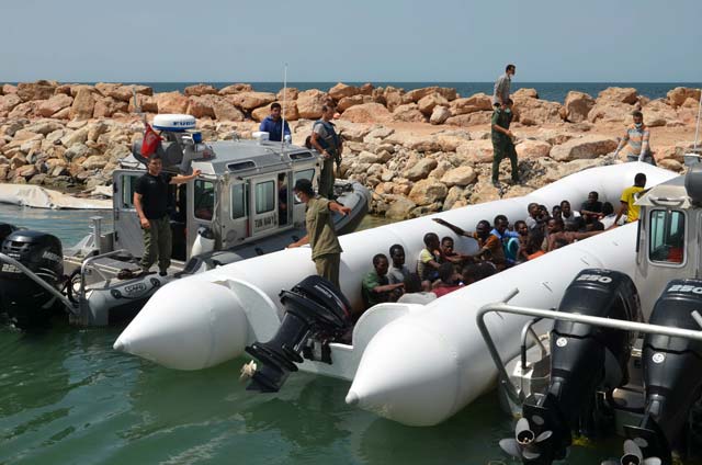migrants arrive at the el kitif port in the tunisian town of ben guerdane some 40 kilometres west of the libyan border following their rescue by tunisia 039 s coastguard and navy after their vessel overturned off libya on august 23 2015 photo afp