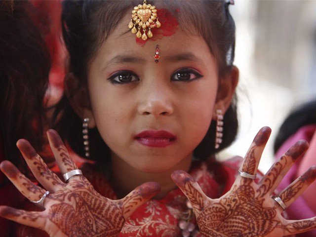 in this file photo a girl shows her palms decorated with henna to the camera during a ceremony photo reuters file