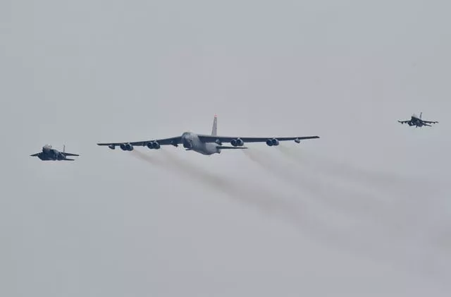 a us b 52 stratofortress c is escorted by a south korean f 15k fighter jet l and a us f 16 fighter jet r as it flies over the osan air base in pyeongtaek south of seoul on january 10 2016 photo afp a us b 52 stratofortress c is escorted by a south korean f 15k fighter jet l and a us f 16 fighter jet r as it flies over the osan air base in pyeongtaek south of seoul on january 10 2016 photo afp