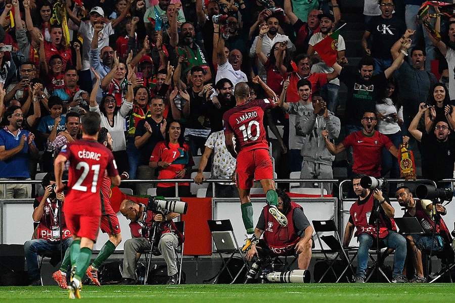 portugal s midfielder joao mario r celebrates after switzerland 039 s defender johan djourou scored an own goal during the fifa world cup 2018 group b qualifier football match between portugal and switzerland at the luz stadium in lisbon on october 10 2017 photo afp