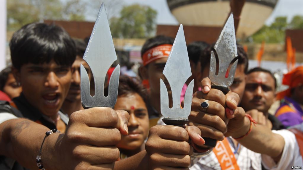 supporters of hardline vishwa hindu parishad vhp hindu group hold tridents in the western indian city of ahmedabad india photo reuters