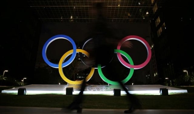 a woman walks past olympic rings placed at the entrance of a office building ahead of the rio 2016 olympic games in sao paulo brazil july 19 2016 photo reuters