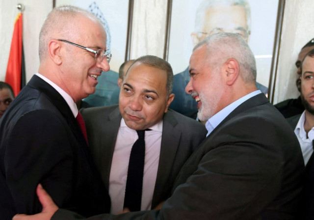prime minister rami hamdallah left shakes hands with hamas chief ismail haniyeh in gaza city on october 2 photo reuters prime minister rami hamdallah left shakes hands with hamas chief ismail haniyeh in gaza city on october 2 photo reuters