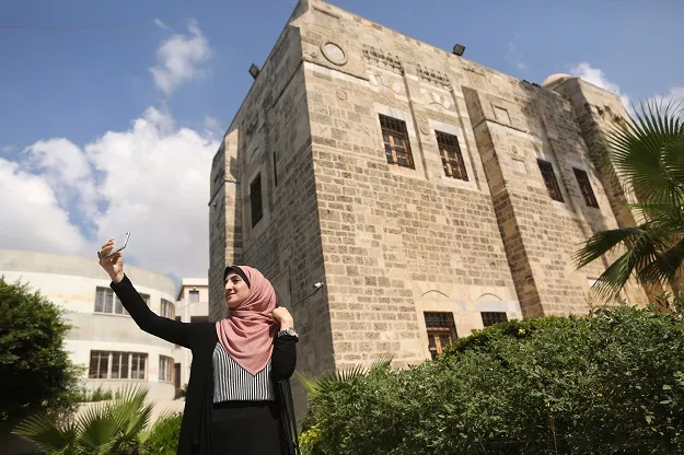 palestinian kholoud nassar 26 uses her mobile phone to take pictures for her social media account in deir al balah in the central gaza strip photo afp palestinian kholoud nassar 26 uses her mobile phone to take pictures for her social media account in deir al balah in the central gaza strip photo afp