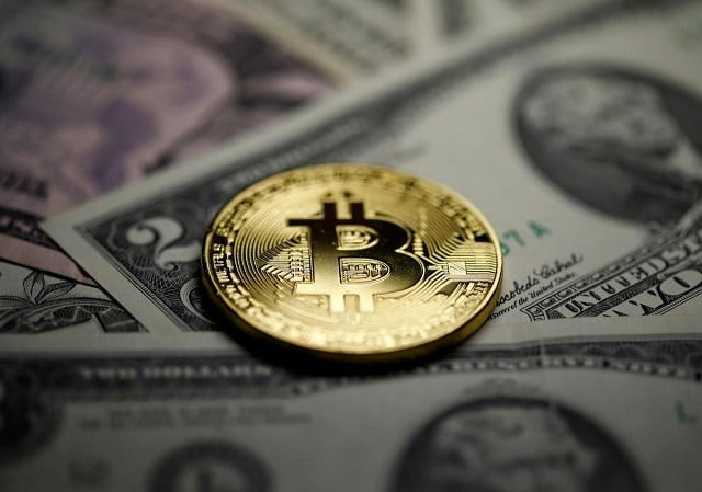 a bitcoin and dollar notes are seen in this illustration picture taken september 27 2017 photo reuters a bitcoin and dollar notes are seen in this illustration picture taken september 27 2017 photo reuters