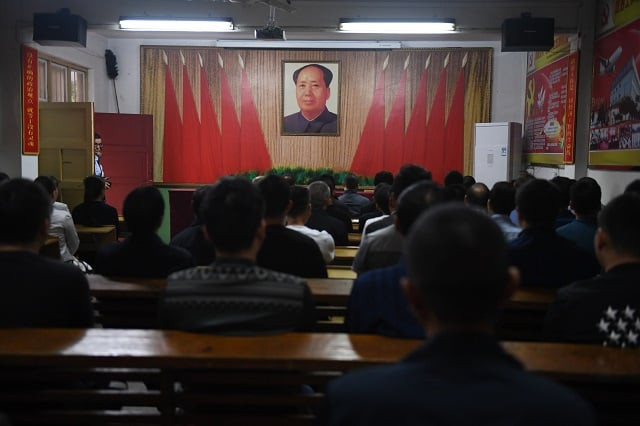 this photo taken on september 27 2017 shows factory managers singing communist 039 red 039 songs at the start of their work day during a journalist visit in nanjie village in china 039 s central henan province every year hundreds of thousands of visitors flock to the hamlet in central henan province which has become an attraction with its idealised vision of village life right out of the communist past while the communist party prepares to give a second term to its current supremo xi jinping at a major congress next week nanjie still clings firmly to mao while glossing over the turbulence and violence of his rule photo afp this photo taken on september 27 2017 shows factory managers singing communist 039 red 039 songs at the start of their work day during a journalist visit in nanjie village in china 039 s central henan province every year hundreds of thousands of visitors flock to the hamlet in central henan province which has become an attraction with its idealised vision of village life right out of the communist past while the communist party prepares to give a second term to its current supremo xi jinping at a major congress next week nanjie still clings firmly to mao while glossing over the turbulence and violence of his rule photo afp