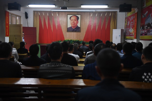 this photo taken on september 27 2017 shows factory managers singing communist 039 red 039 songs at the start of their work day during a journalist visit in nanjie village in china 039 s central henan province every year hundreds of thousands of visitors flock to the hamlet in central henan province which has become an attraction with its idealised vision of village life right out of the communist past while the communist party prepares to give a second term to its current supremo xi jinping at a major congress next week nanjie still clings firmly to mao while glossing over the turbulence and violence of his rule photo afp