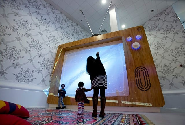 a woman and young children interact with a giant television set at the ann riches healing space for young patients at the royal london hospital in london february 22 2013 photo reuters a woman and young children interact with a giant television set at the ann riches healing space for young patients at the royal london hospital in london february 22 2013 photo reuters