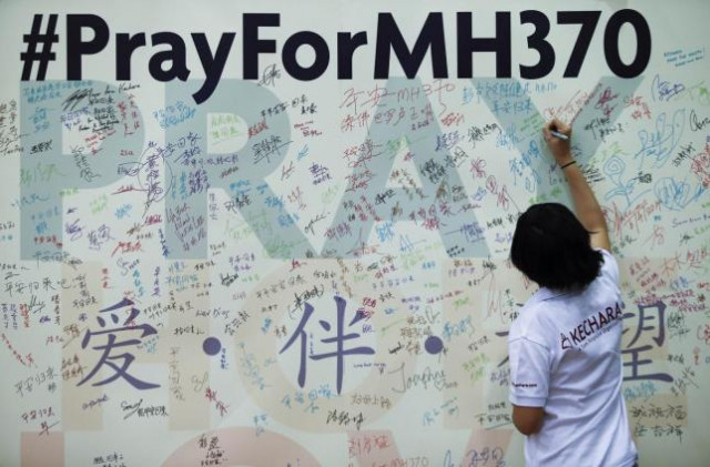 a woman writes a message on a board for family members of passengers onboard the missing malaysia airlines flight mh370 at the mca headquarters in kuala lumpur photo reuters a woman writes a message on a board for family members of passengers onboard the missing malaysia airlines flight mh370 at the mca headquarters in kuala lumpur photo reuters
