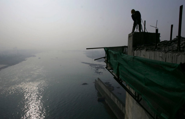 a labourer works on a reservoir photo reuters a labourer works on a reservoir photo reuters