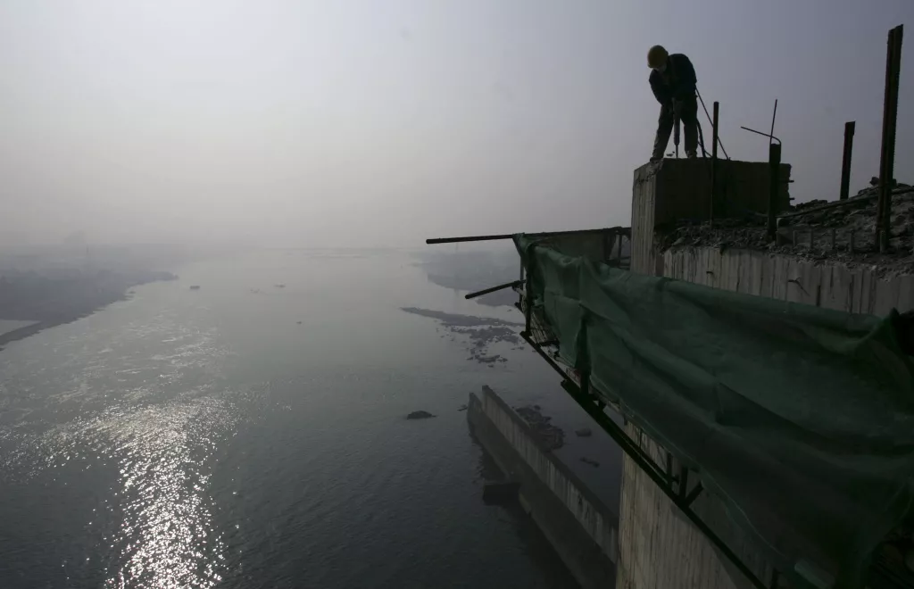 a labourer works on a reservoir photo reuters a labourer works on a reservoir photo reuters