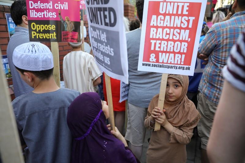 children hold placards during a vigil near to where a van was driven at muslims in finsbury park north london britain photo reuters