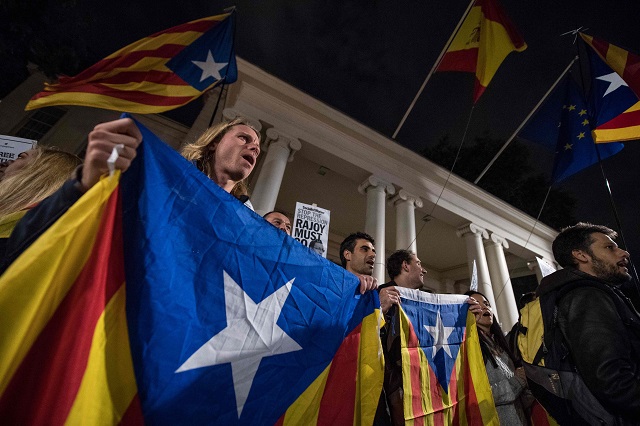 protestors wave and wear catalan pro independence 039 estelada 039 flags as they demonstrate outside the spanish embassy in london on october 17 2017 following the detention of spanish separatist leaders jordi cuixart and jordi sanchez thousands of people took to the streets of catalonia tuesday after a judge ordered the detention of two separatist leaders jordi cuixart and jordi sanchez further inflaming tensions over the region 039 s chaotic referendum on splitting from spain photo afp