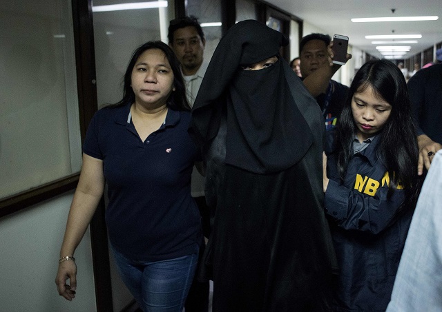 karen aizha hamidon is escorted by national bureau of investigation nbi personnels after a press conference where hamidon was presented in manila on october 18 2017 authorities have arrested hamidon who allegedly used the internet and social media to recruit followers around the world for islamist quot terrorist acts quot government lawmen said hamidon 36 was arrested on october 11 in her home in a suburb of the philippine capital on charges of inciting to rebellion said officials of the government national buerau of investigation photo afp