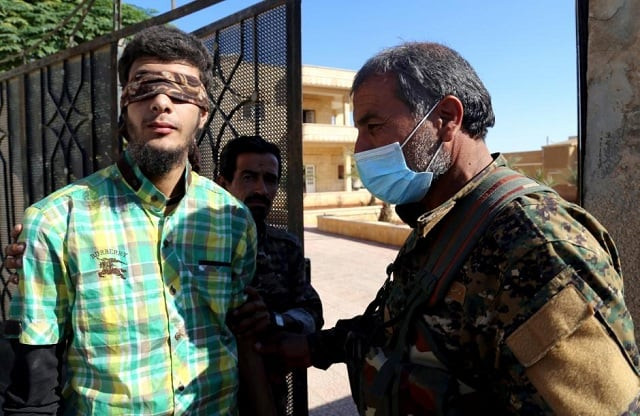 members of syrian democratic forces escort a blindfolded civilian detainee suspected to be a member of islamic state militants in raqqa photo reuters members of syrian democratic forces escort a blindfolded civilian detainee suspected to be a member of islamic state militants in raqqa photo reuters