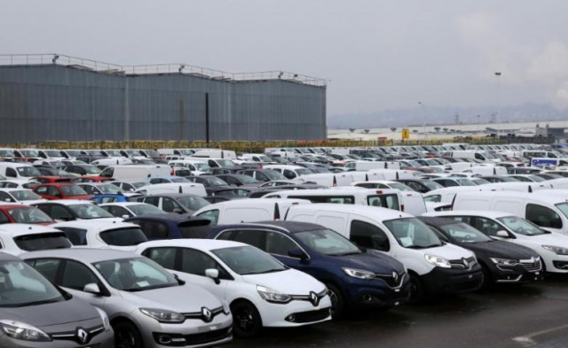 rows cars and vans parked outside a automobile plant photo reuters rows cars and vans parked outside a automobile plant photo reuters
