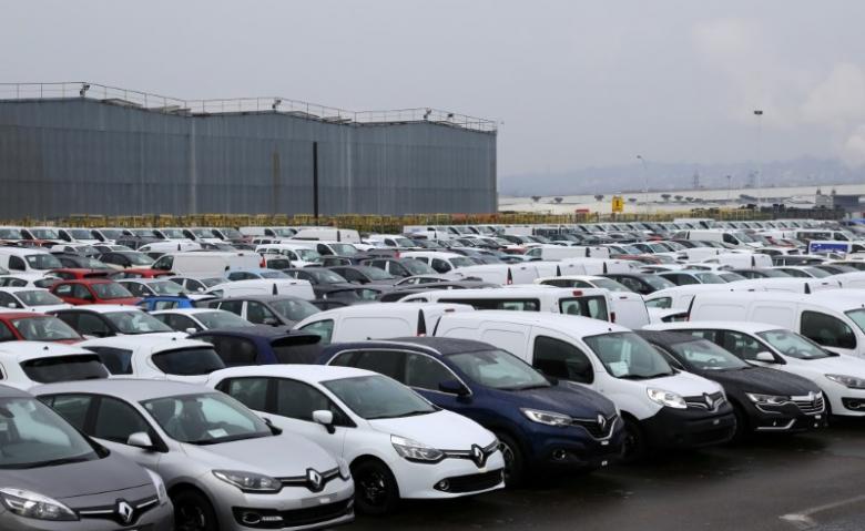 rows cars and vans parked outside a automobile plant photo reuters