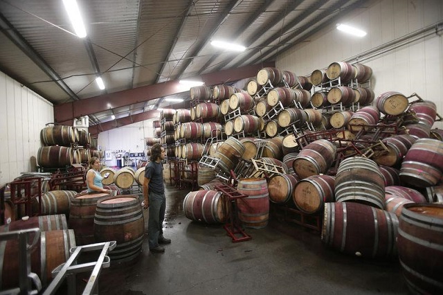 a man surveys fallen wine barrels after a 6 0 earthquake in napa california on august 24 2014 photo reuters