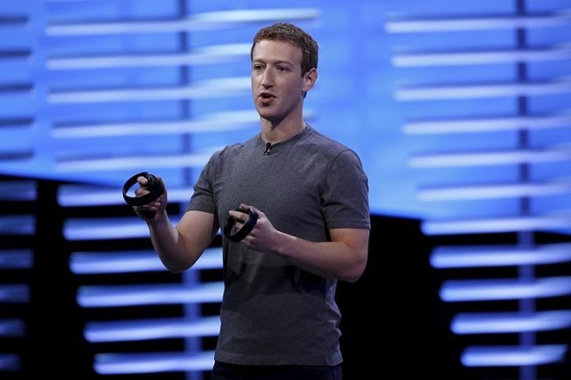 facebook ceo mark zuckerberg holds a pair of the touch controllers for the oculus rift virtual reality headsets on stage during the facebook f8 conference in san francisco california april 12 2016 photo reuters