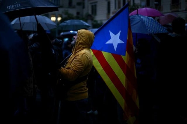 a demonstrator holds an estelada catalan separatist flag during a gathering in front of the spanish central government headquarters in barcelona to protest against the imprisonment of leaders of two of the largest catalan separatist organisations photo reuters a demonstrator holds an estelada catalan separatist flag during a gathering in front of the spanish central government headquarters in barcelona to protest against the imprisonment of leaders of two of the largest catalan separatist organisations photo reuters