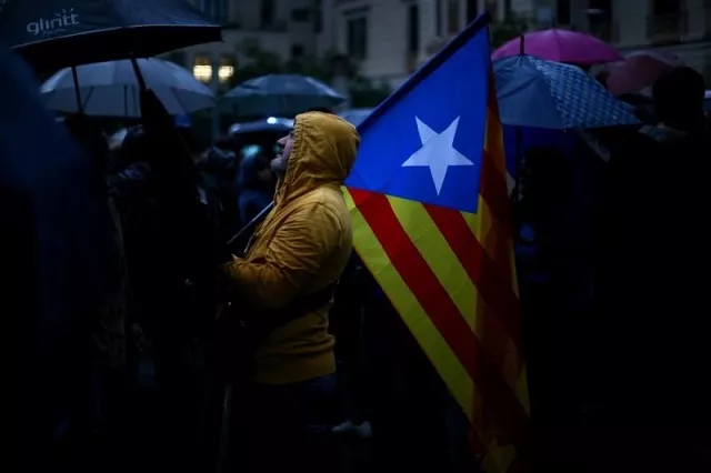 a demonstrator holds an estelada catalan separatist flag during a gathering in front of the spanish central government headquarters in barcelona to protest against the imprisonment of leaders of two of the largest catalan separatist organisations photo reuters a demonstrator holds an estelada catalan separatist flag during a gathering in front of the spanish central government headquarters in barcelona to protest against the imprisonment of leaders of two of the largest catalan separatist organisations photo reuters
