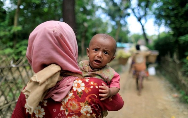 rohingya refugees who crossed the border from myanmar two days earlier walk after they received permission from the bangladesh army to continue their way to the kutupalong refugee camp in balukhali near cox 039 s bazar bangladesh photo reuters