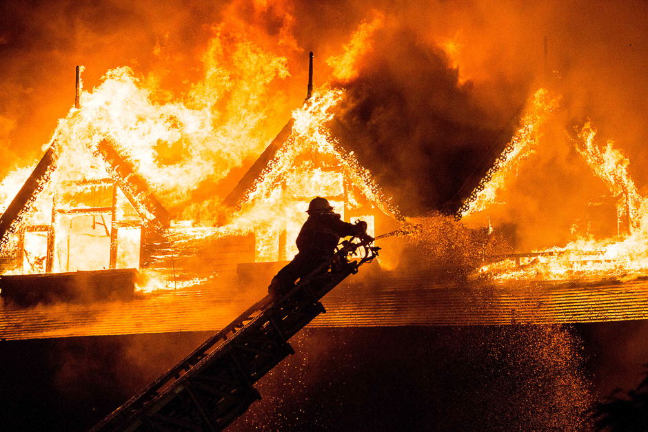 a firefighter extinguishes a fire at kandawgyi palace hotel in yangon photo afp