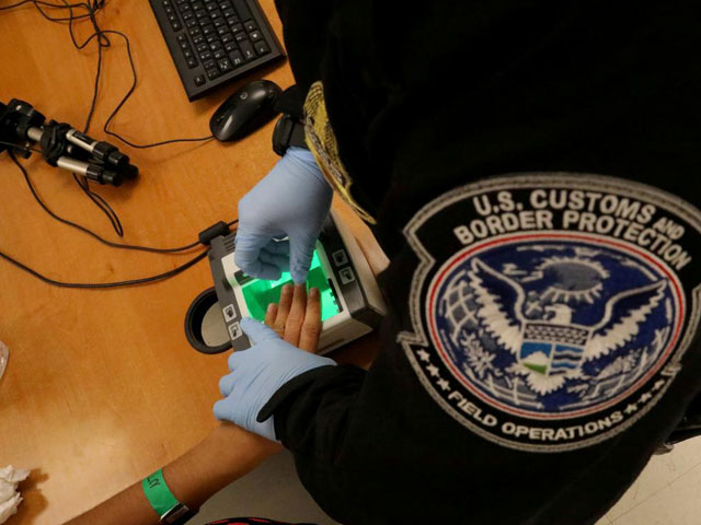 a woman who is seeking asylum has her fingerprints taken by a us customs and border patrol officer at a pedestrian port of entry from mexico to the united states in mcallen texas us may 10 2017 photo reuters