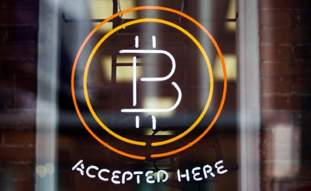 a bitcoin sign is seen in a window in toronto canada may 8 2014 photo reuters a bitcoin sign is seen in a window in toronto canada may 8 2014 photo reuters